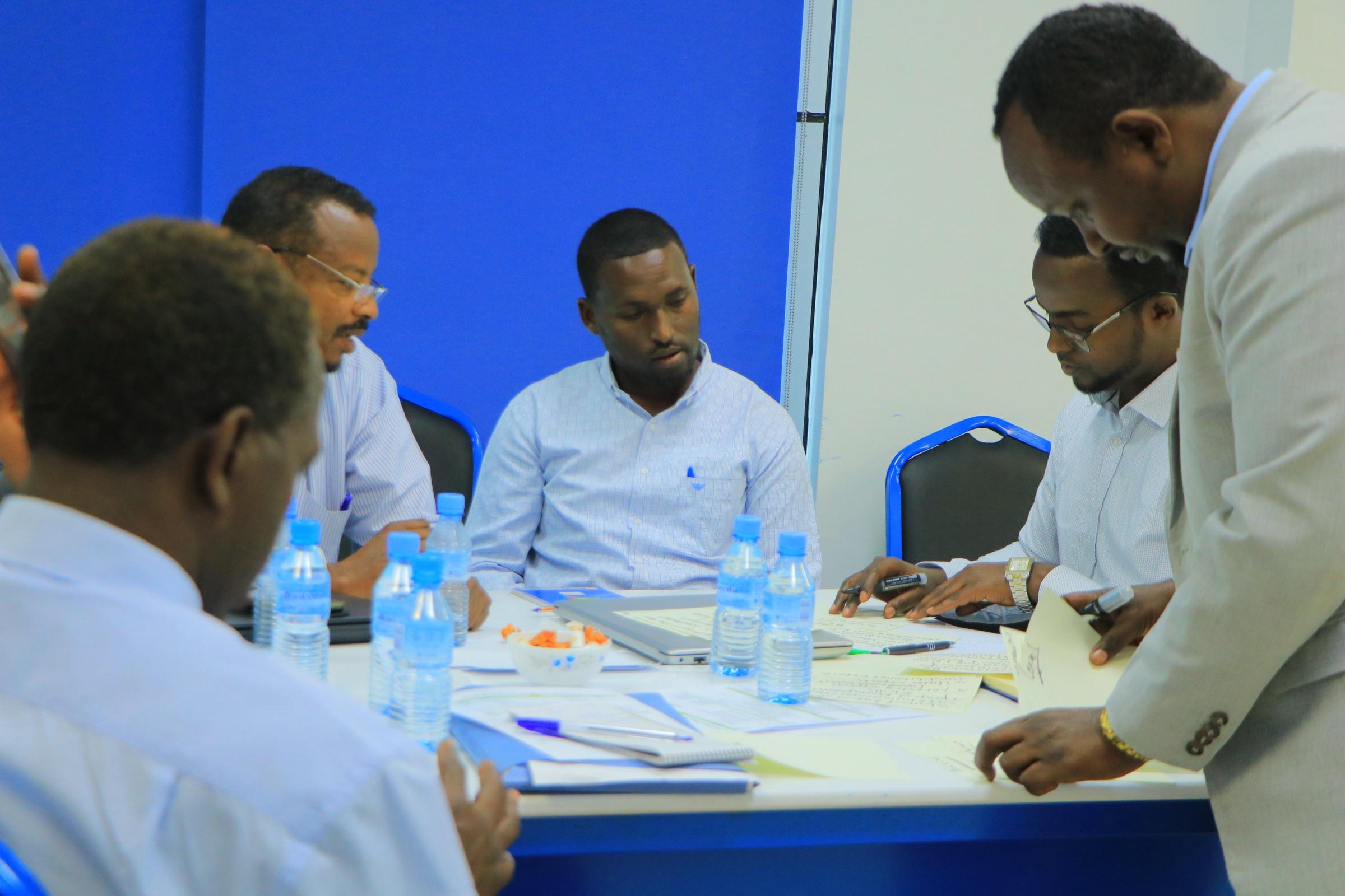 Advisers and client staff working through detail at the table